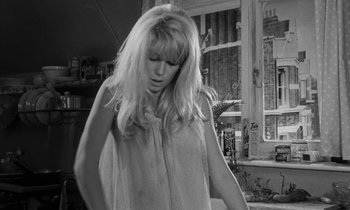 Movie still from “Repulsion” (1965), directed by Roman Polanski – A black - and - white photo of a woman with long blonde hair; Medium shot, Low angle