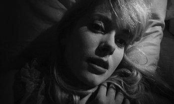 Movie still from “Repulsion” (1965), directed by Roman Polanski – A woman's face in black - and - white photo; Close Up shot, Overhead angle