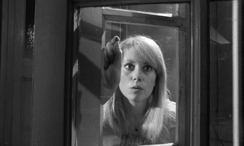 Movie still from “Repulsion” (1965), directed by Roman Polanski – A black - and - white photo of a woman looking in a mirror; Close Up shot, Low angle
