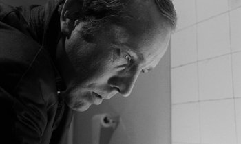 Movie still from “Repulsion” (1965), directed by Roman Polanski – Black and white photograph of a man looking down; Close Up shot, Low angle