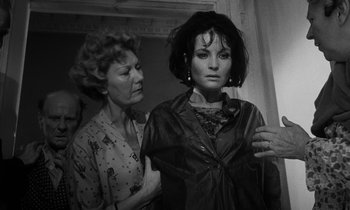 Movie still from “Repulsion” (1965), directed by Roman Polanski – A woman and a woman standing next to each other in a room; Medium shot, Over the shoulder angle
