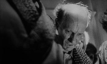 Movie still from “Repulsion” (1965), directed by Roman Polanski – An old man is looking at a woman; Close Up shot, Over the shoulder angle