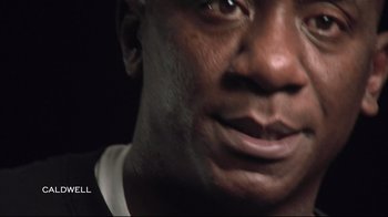 Movie still from “Restrepo” (2010), directed by Tim Hetherington – A man's face in a dark room; Extreme Close Up shot, Low angle