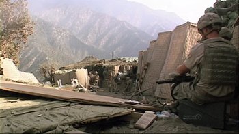 Movie still from “Restrepo” (2010), directed by Tim Hetherington – A group of people standing on top of a mountain; Wide shot, Low angle