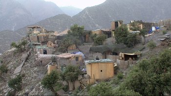 Movie still from “Restrepo” (2010), directed by Tim Hetherington – An aerial view of a small village in a mountainous area; Extreme Wide shot, High angle