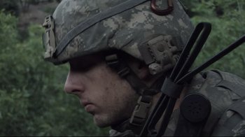 Movie still from “Restrepo” (2010), directed by Tim Hetherington – A soldier wearing a helmet; Close Up shot, Low angle