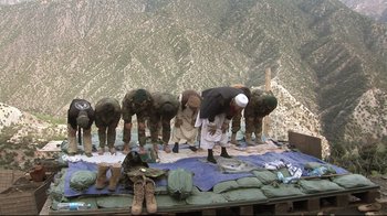 Movie still from “Restrepo” (2010), directed by Tim Hetherington – A group of men standing on top of a mountain; Wide shot, High angle