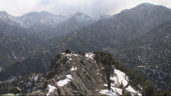 Movie still from “Restrepo” (2010), directed by Tim Hetherington – A view of a mountain range with snow on the ground; Extreme Wide shot, High angle