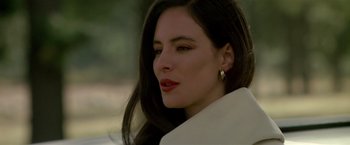 Movie still from “Revenge” (1990), directed by Tony Scott – A person with long hair; Close Up shot, Over the shoulder angle