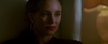 Movie still from “Revenge” (1990), directed by Tony Scott – A person wearing a black shirt; Close Up shot, Over the shoulder angle