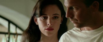 Movie still from “Revenge” (1990), directed by Tony Scott – A woman's face and a man's face; Close Up shot, Over the shoulder angle