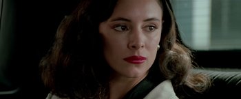 Movie still from “Revenge” (1990), directed by Tony Scott – A person wearing a black jacket; Close Up shot, Over the shoulder angle