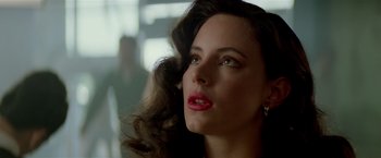 Movie still from “Revenge” (1990), directed by Tony Scott – A person with long brown hair; Close Up shot, Low angle