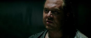 Movie still from “Revenge” (1990), directed by Tony Scott – A person wearing a leather jacket; Close Up shot, Low angle