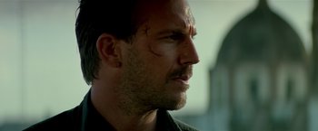 Movie still from “Revenge” (1990), directed by Tony Scott – A person with a scar on his face; Close Up shot, Low angle