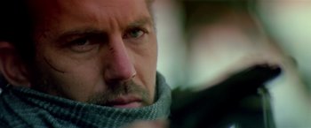 Movie still from “Revenge” (1990), directed by Tony Scott – A person wearing a scarf; Close Up shot, Over the shoulder angle