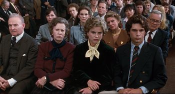 Movie still from “Reversal of Fortune” (1990), directed by Barbet Schroeder – A group of people sitting in front of each other; Medium shot, High angle