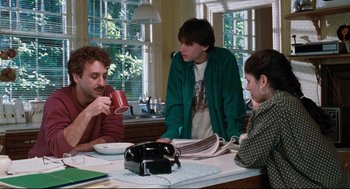 Movie still from “Reversal of Fortune” (1990), directed by Barbet Schroeder – A group of people sitting around a table; Medium shot, Low angle