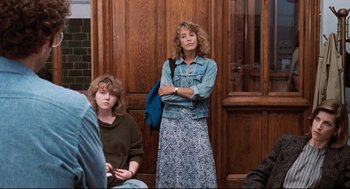Movie still from “Reversal of Fortune” (1990), directed by Barbet Schroeder – A woman standing next to another woman in a doorway; Medium shot, Over the shoulder angle