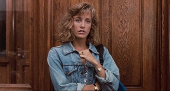 Movie still from “Reversal of Fortune” (1990), directed by Barbet Schroeder – A woman in a jean jacket holding a purse; Close Up shot, Low angle