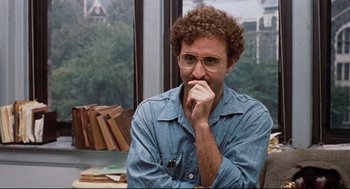 Movie still from “Reversal of Fortune” (1990), directed by Barbet Schroeder – A man sitting in front of a window with his hand under his chin; Close Up shot, Over the shoulder angle