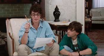 Movie still from “Reversal of Fortune” (1990), directed by Barbet Schroeder – A woman sitting next to a man on a couch; Medium shot, Over the shoulder angle