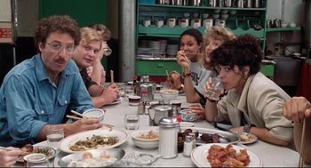 Movie still from “Reversal of Fortune” (1990), directed by Barbet Schroeder – A group of people sitting at a table eating food; Medium shot, High angle