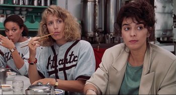 Movie still from “Reversal of Fortune” (1990), directed by Barbet Schroeder – Two women sitting at a table in front of a bowl; Medium shot, Over the shoulder angle