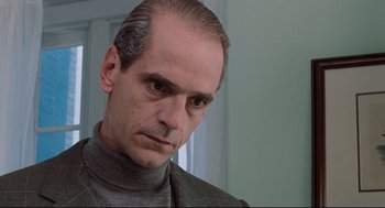 Movie still from “Reversal of Fortune” (1990), directed by Barbet Schroeder – A person wearing a sweater; Close Up shot, Low angle