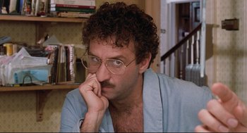 Movie still from “Reversal of Fortune” (1990), directed by Barbet Schroeder – A person wearing glasses; Close Up shot, High angle