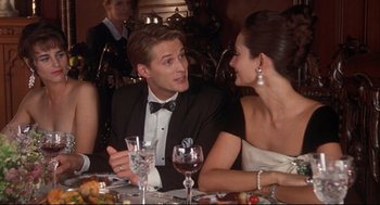Movie still from “Reversal of Fortune” (1990), directed by Barbet Schroeder – A man and a woman sitting at a dinner table; Medium shot, Over the shoulder angle