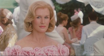 Movie still from “Reversal of Fortune” (1990), directed by Barbet Schroeder – A person wearing a dress; Close Up shot, Over the shoulder angle