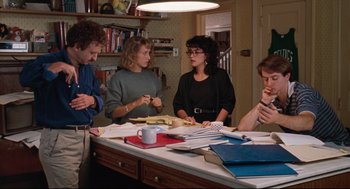 Movie still from “Reversal of Fortune” (1990), directed by Barbet Schroeder – A group of people sitting around a table; Medium shot, High angle
