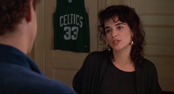 Movie still from “Reversal of Fortune” (1990), directed by Barbet Schroeder – A woman in a black shirt is talking to a man; Close Up shot, Over the shoulder angle