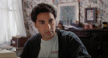 Movie still from “Reversal of Fortune” (1990), directed by Barbet Schroeder – A person wearing a t - shirt; Close Up shot, Over the shoulder angle