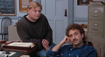 Movie still from “Reversal of Fortune” (1990), directed by Barbet Schroeder – Two men sitting in a room next to each other; Medium shot, High angle