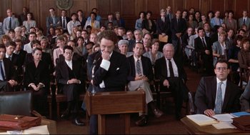 Movie still from “Reversal of Fortune” (1990), directed by Barbet Schroeder – A crowd of people sitting in a courtroom; Wide shot, High angle