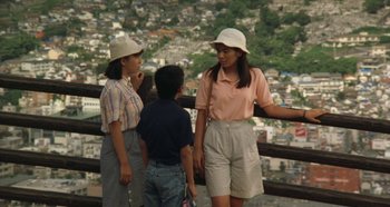 Movie still from “Rhapsody in August” (1991), directed by Akira Kurosawa – A group of people standing next to each other on top of a hill; Medium shot, High angle