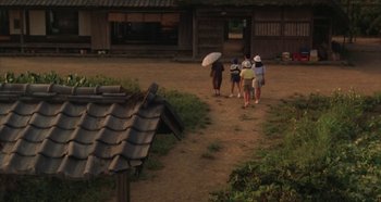 Movie still from “Rhapsody in August” (1991), directed by Akira Kurosawa – A group of people walking down a dirt path; Extreme Wide shot, High angle