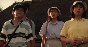 Movie still from “Rhapsody in August” (1991), directed by Akira Kurosawa – A group of young people standing next to each other; Medium shot, Low angle