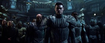 Movie still from “Riddick” (2013), directed by David Twohy – A group of men wearing armor in a room; Medium shot, Low angle
