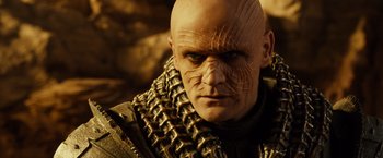 Movie still from “Riddick” (2013), directed by David Twohy – A person wearing a mask; Close Up shot, Low angle