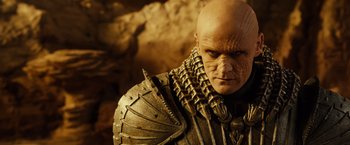 Movie still from “Riddick” (2013), directed by David Twohy – A person wearing a costume; Close Up shot, Low angle