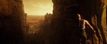 Movie still from “Riddick” (2013), directed by David Twohy – A view of a valley from the top of a cliff; Extreme Wide shot, Overhead angle