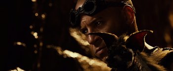 Movie still from “Riddick” (2013), directed by David Twohy – A person wearing goggles; Close Up shot, Over the shoulder angle