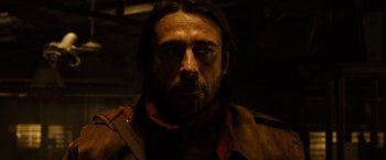 Movie still from “Riddick” (2013), directed by David Twohy – A person with a beard; Close Up shot, Low angle