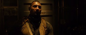 Movie still from “Riddick” (2013), directed by David Twohy – A person wearing a jacket; Close Up shot, Over the shoulder angle