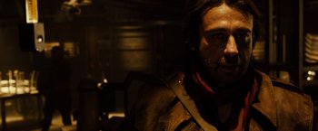 Movie still from “Riddick” (2013), directed by David Twohy – A person with a beard; Close Up shot, Over the shoulder angle