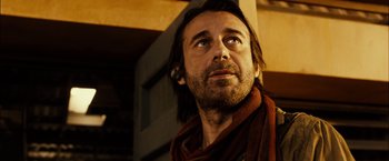 Movie still from “Riddick” (2013), directed by David Twohy – A person with a beard looking up; Close Up shot, Low angle