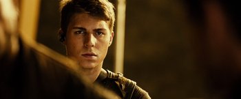Movie still from “Riddick” (2013), directed by David Twohy – A young man is looking into the camera; Close Up shot, Over the shoulder angle